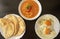 Peeled fava beans with chili pepper in white bowl  pita bread and fried eggs on dark wooden background