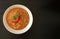 Peeled fava beans with chili in white bowl on dark wooden background with copy space