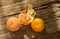 Peeled fresh organic oranges on rustic wood background.