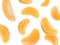 Peeled fresh tangerine pieces falling on white background