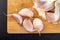 Peeled garlic cloves on a wooden board. Natural methods to prevent colds