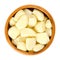 Peeled garlic cloves in wooden bowl over white