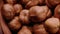 Peeled grains of hazelnuts in an earthenware bowl. Close-up. Slow rotation. 4k video