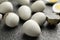 Peeled hard boiled quail eggs on grey table, closeup