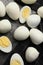 Peeled hard boiled quail eggs on grey table, flat lay