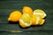 Peeled lemon and whole lemons on a rough wooden background