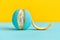 Peeled lobule peel of an orange painted in turquoise color. creative design concept