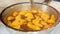 Peeled mandarin orange fillets with sugar in a pan