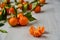 Peeled mandarin orange and juicy tangerine orange slices on the gray wooden board. Citrus background. Fresh raw tangerines