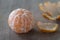 Peeled mandarine fruit on wooden board