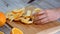 Peeled orange on wooden cutting board.