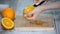 Peeled orange on wooden cutting board.