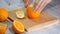 Peeled orange on wooden cutting board.