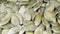 Peeled pumpkin seeds close-up. Organic seed kernels. Macro. 4K video.