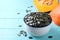 Peeled pumpkin seeds on light blue wooden table, closeup