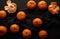 Peeled ripe orange mandarin and a bunch of unpeeled round whole fruits on a black napkin