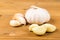 Peeled and sliced garlic cloves with whole garlic bulb and cloves as background