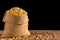 Peeled soybean in small sack on wooden table. Isolated on black