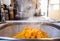 Peeled and square-shaped cuts of hot mango in a  metal strainer in the kitchen