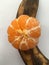 Peeled tangerine lying on a unpeeled banana. Minimalism. Abstraction.