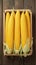 Peeled yellow corn on wooden table Fresh and appetizing display