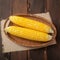 Peeled yellow corn on wooden table Fresh and appetizing display