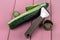 Peeler for cleaning vegetables and fruits with cucumber with peeled skin on a pink