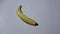Peeling of banana on a white background, stop motion, animation.