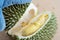 peeling durian by hand Tropical seasonal fruit, king of fruit from Thailand. The durian peel, glove, knife.