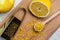 Peeling lemon rind to add zest to Mediterranean recipes. Grater peel and lemon zest on light background, place for text, top view