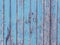 Peeling light blue paint on vintage wooden wall