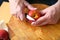 Peeling peach over cutting board