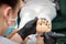 Peeling pedicure procedure on the sole from callus of the female foot by a pedicurist at a beauty salon.