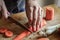 Peeling and slicing carrots close up. Girly hands preparing food