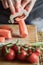 Peeling and slicing carrots close up. Girly hands preparing food