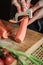 Peeling and slicing carrots close up. Girly hands preparing food