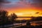 Pegwell Bay during sunset after a rain storm. The sea and roads are golden as they reflect the dramatic, colourful sky.