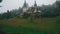 Peles Castle and a Misty Pine Tree Forest in Sinaia, Transylvania, Romania - Ultra Wide Angle Front View