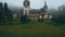 Peles Castle and a Misty Pine Tree Forest in Sinaia, Transylvania, Romania - Wide Angle Front View