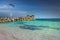 Pelican flying over caribbean beach with pier and gazebo, Montego Bay, Jamaica