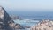 Pelicans flock, rocky cliff island, ocean, Point Lobos, California. Birds flying