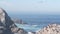 Pelicans flock, rocky cliff island, ocean, Point Lobos, California. Birds flying