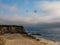 Pelicans fly above Half moon bay beach