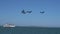 Pelicans over the Pacific Ocean flying by Alcatraz Island with an Alcatraz tour boat in the background