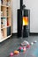 Pellet stove with some toys in front, with flames and library