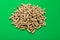 Pellets Biomass. Wood pellets on a green background , copy space.