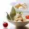 Pelmeni dumpling ravioli tomato bay leaf white background cloves, fennel, reflection plates beautifully appetizing food