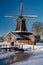 Pelmolen Ter Horst, Rijssen covered in snowy landscape in Overijssel Netherlands, historical wind mill during winter