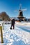 Pelmolen Ter Horst, Rijssen covered in snowy landscape in Overijssel Netherlands, historical wind mill during winter