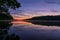 Pemaquid River in Maine is calm and vibrant with deep purple hues on a summer morning at sunrise